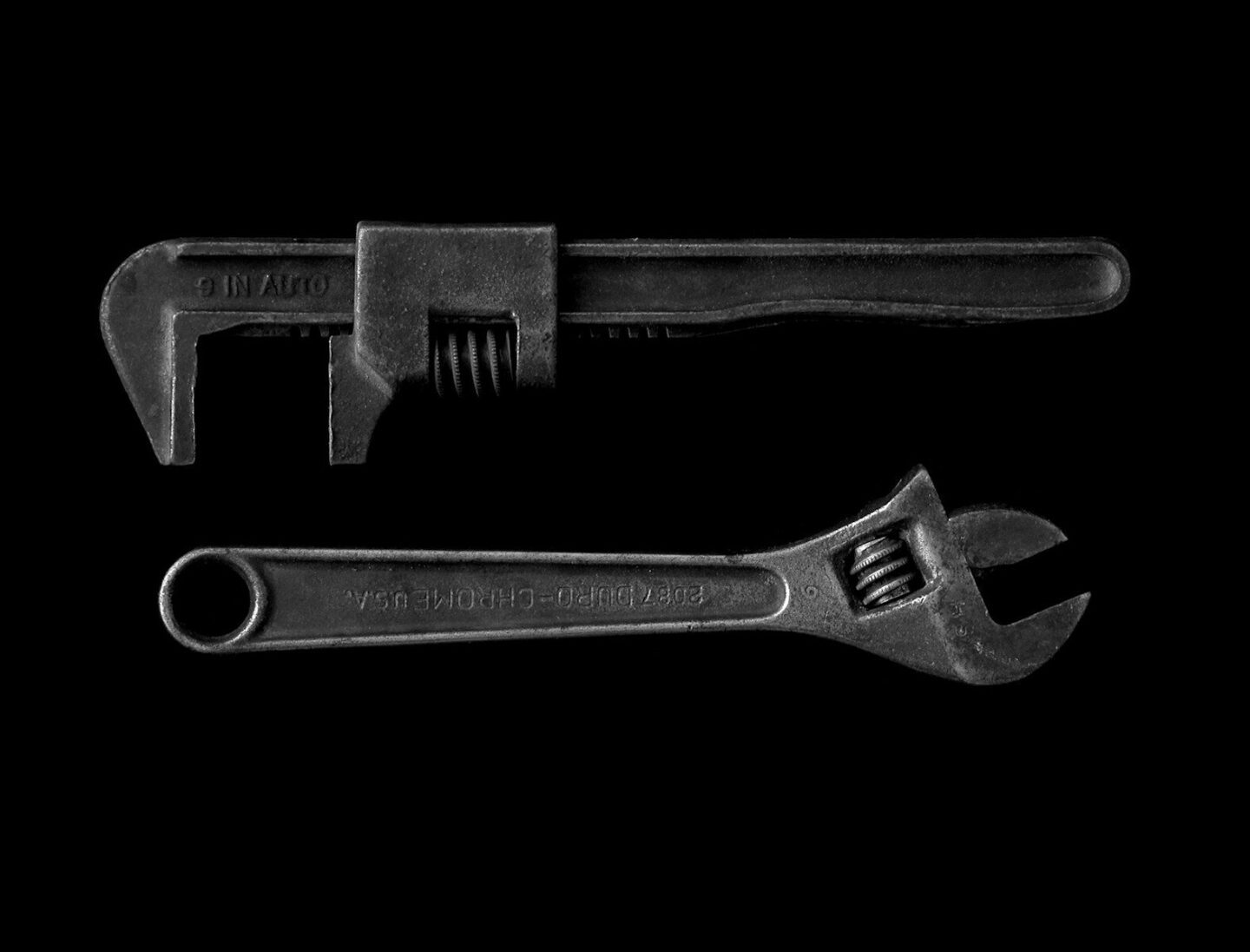 silver adjustable wrench and pipe wrench