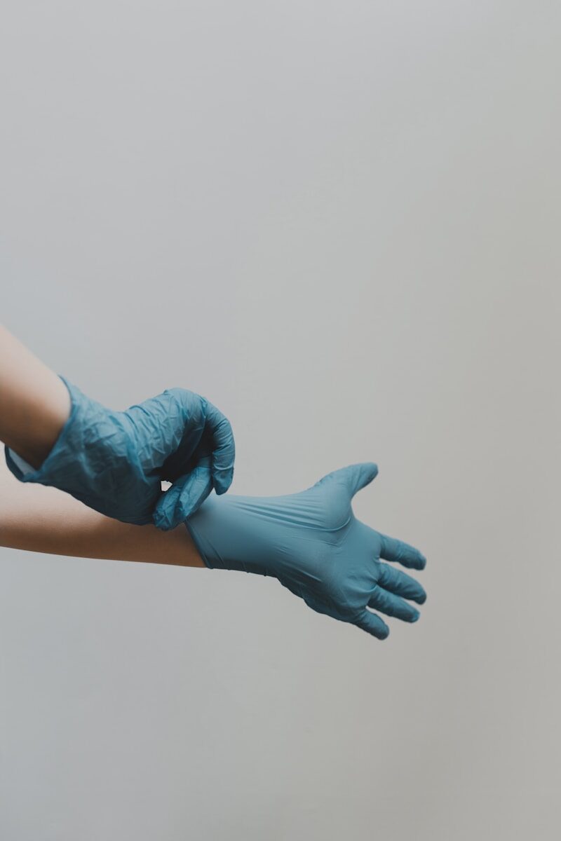 person 's hands in blue gloves for surgery