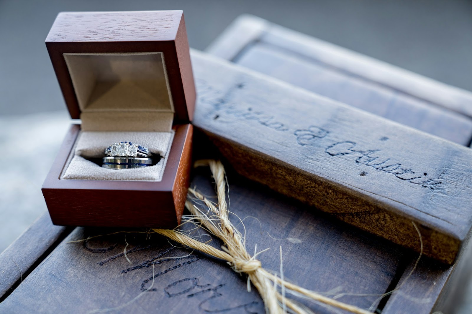 engagement ring in box on wooden plinth