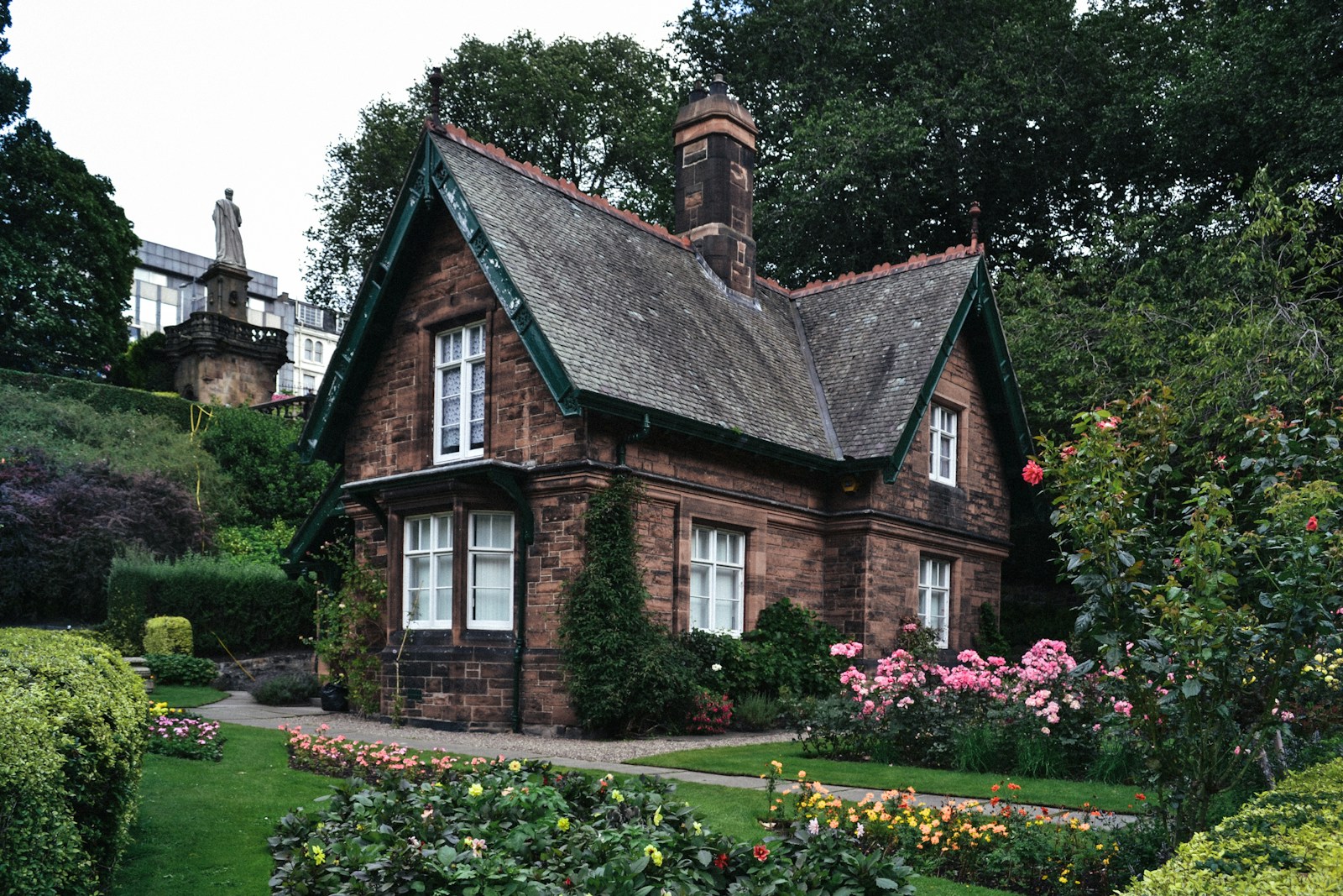 brown brick house surrounded by garden