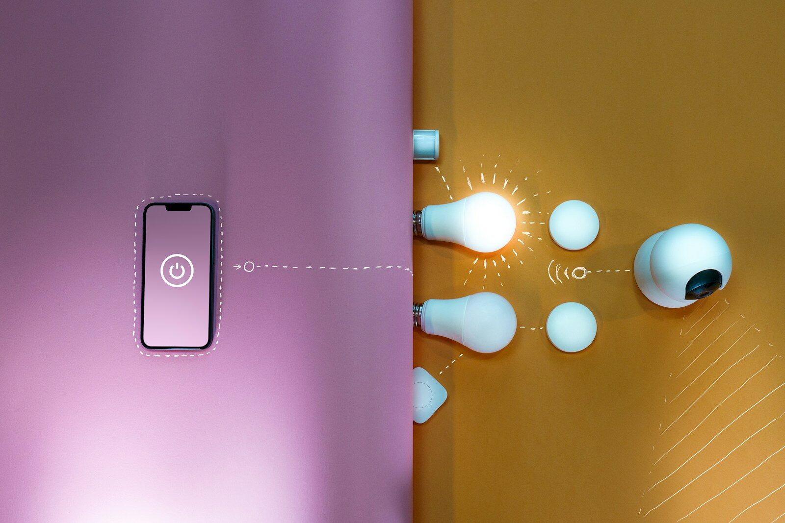 a mobile phone on pink surface showing a connection to smart home appliances - bulbs and switches