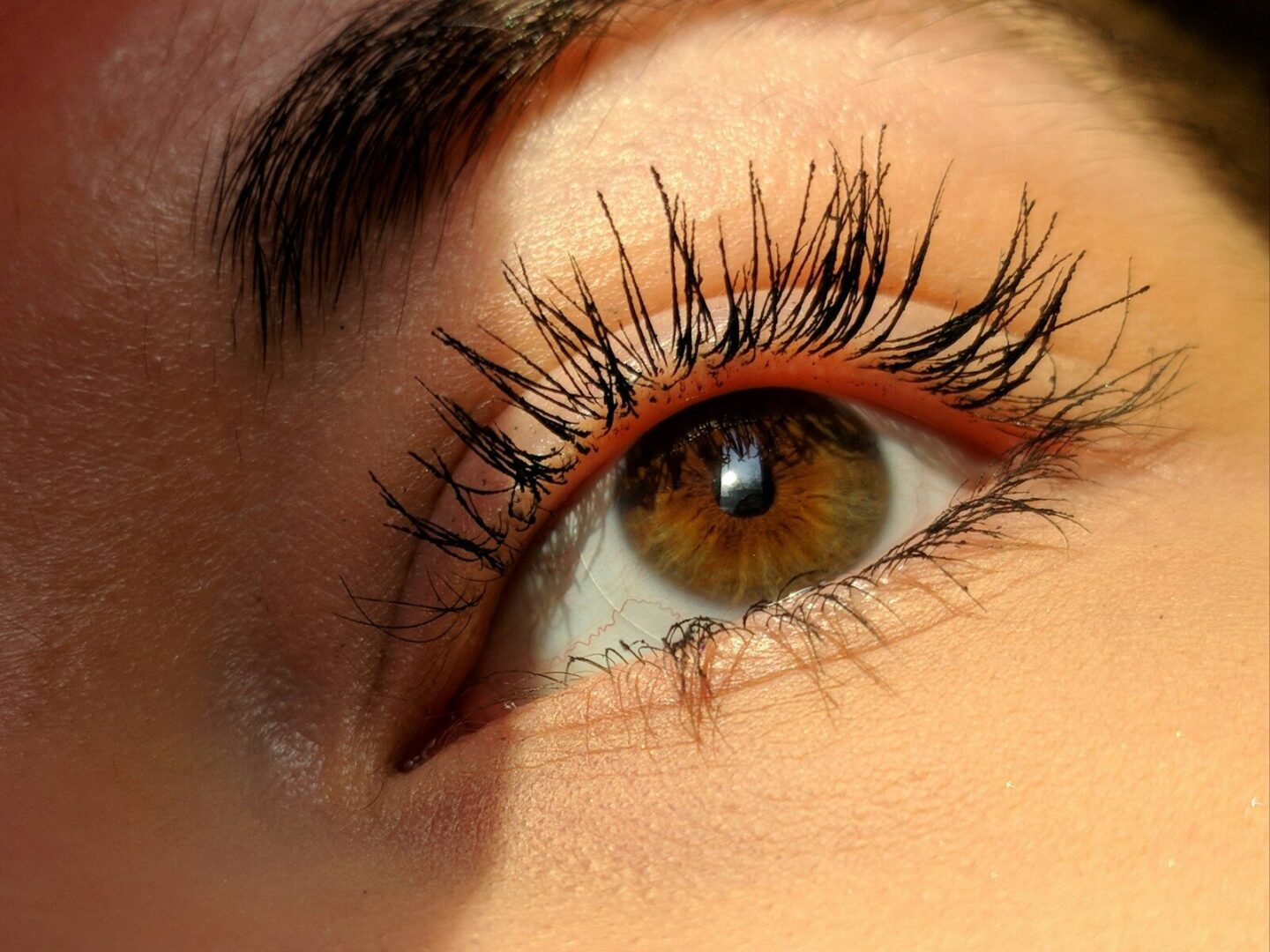 woman's left eye with long eyelashes up close