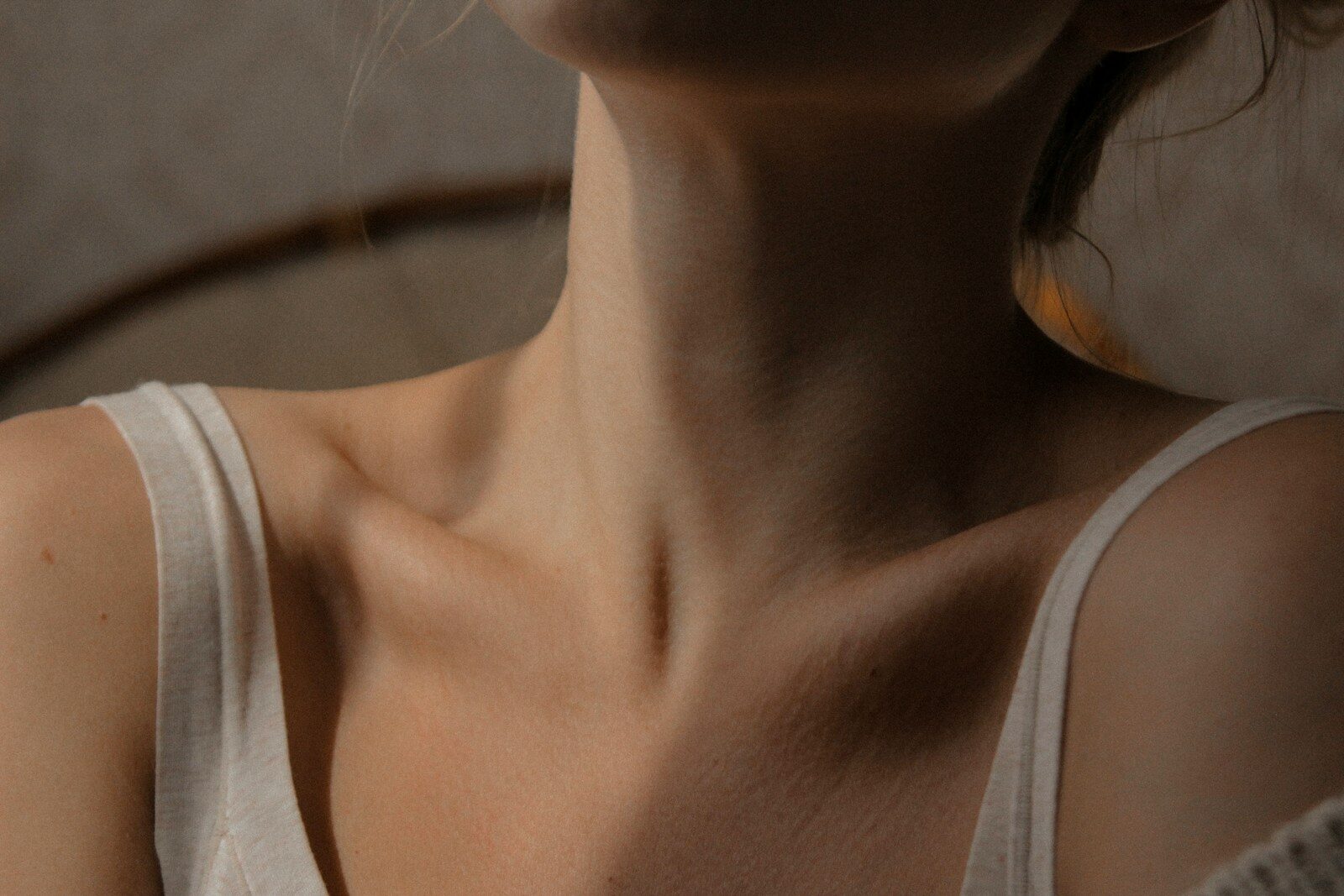 woman in white tank top up close