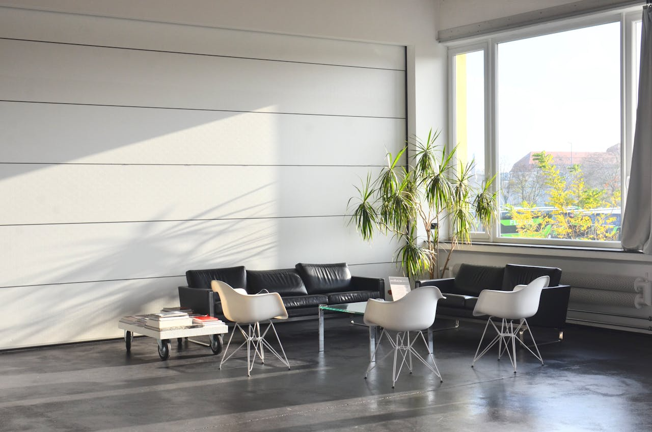 open space with brown leather sofas and white chairs