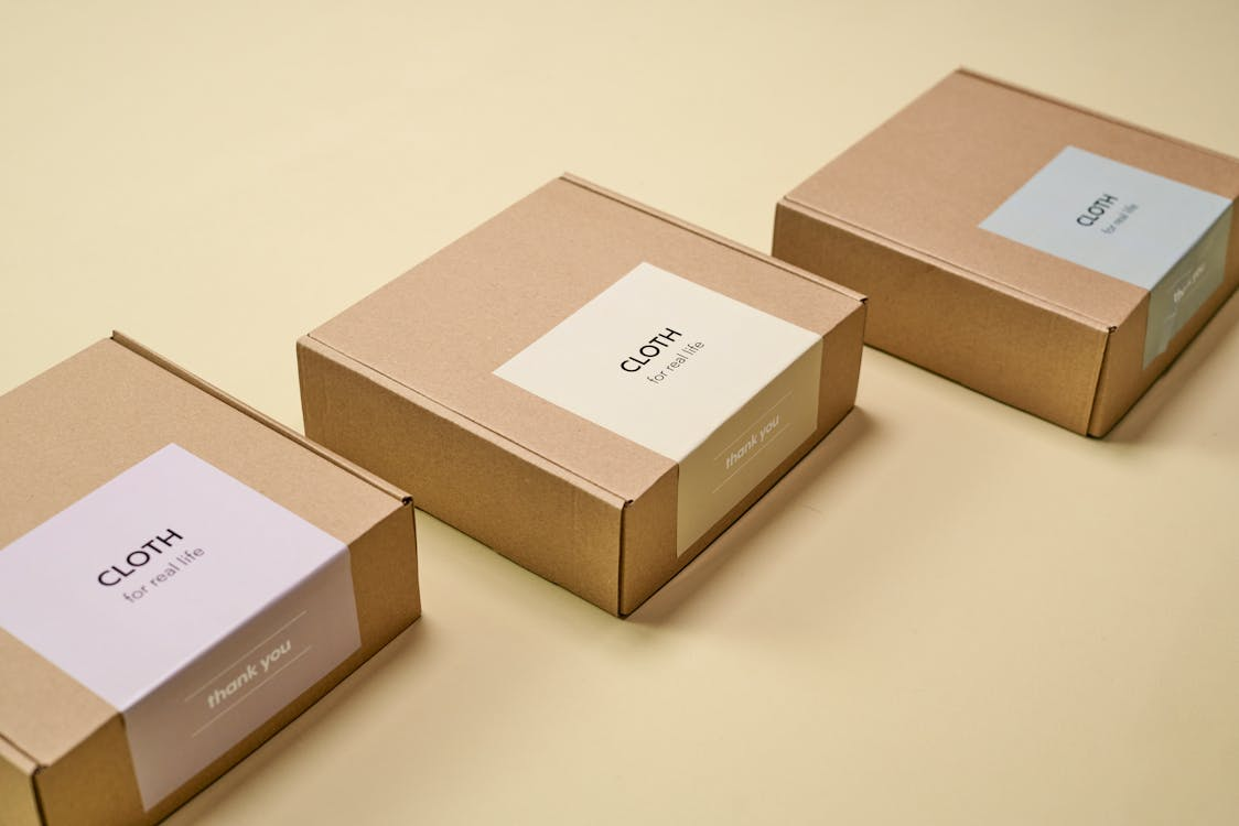 3 cardboard boxes with 'cloth' branding on them