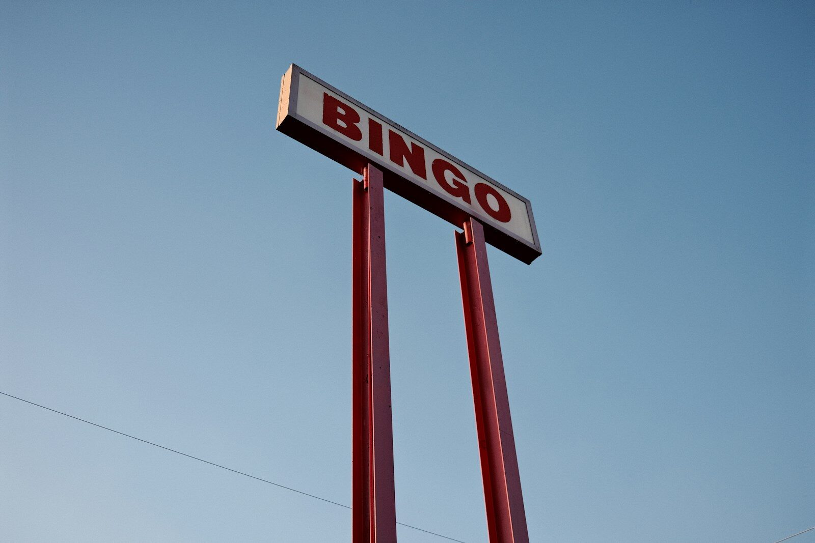 red and white bingo sign in front of blue sky