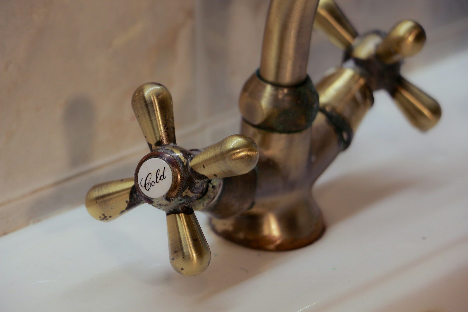 Antique brass tap with hot and cold handles
