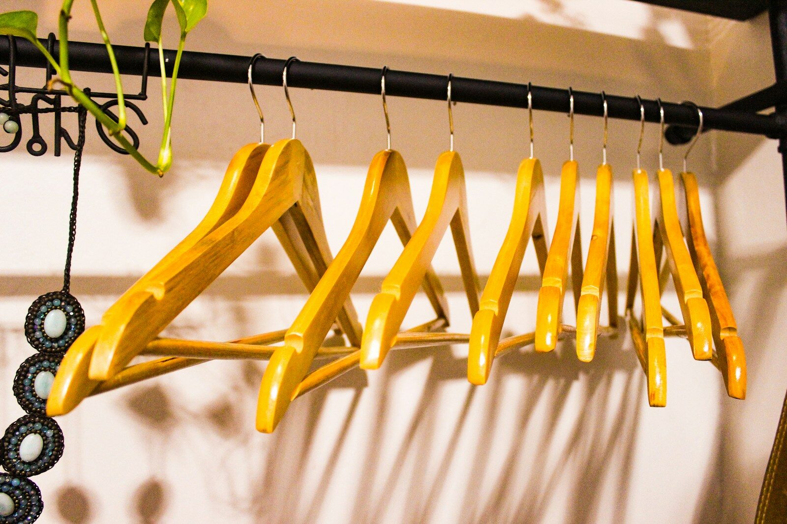 a rack of empty coathangers hanging on a rail