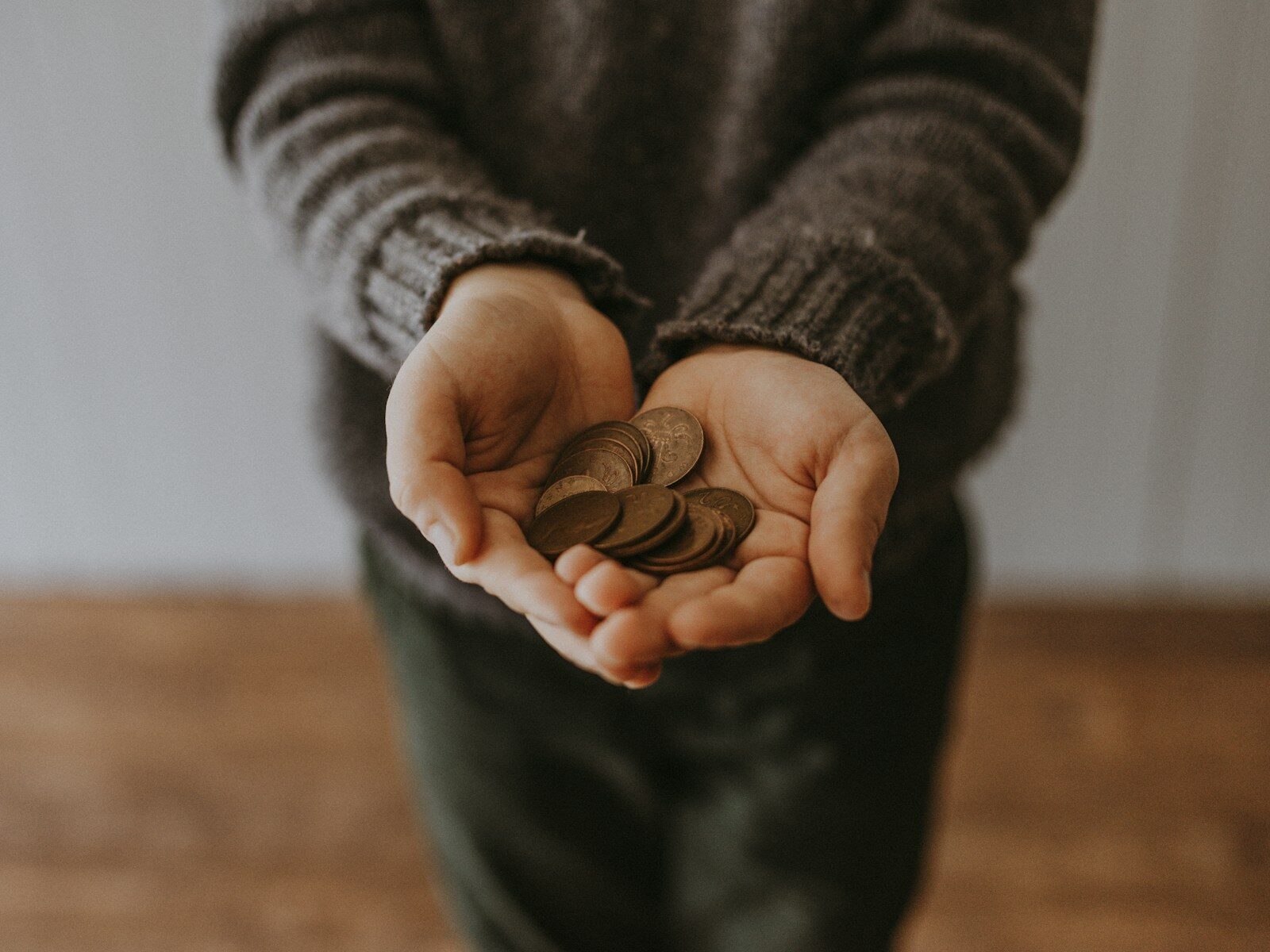 copper-coloured coins in child's hands