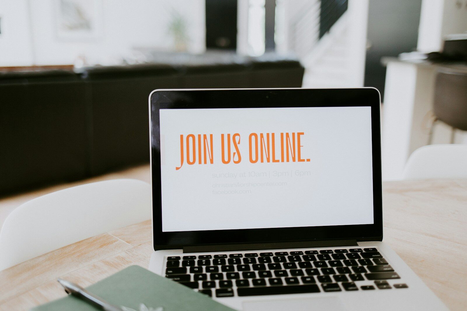 open laptop on table with the words 'join us online' on the screen