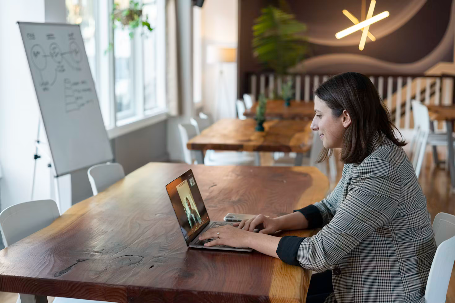 woman sitting at table on laptop