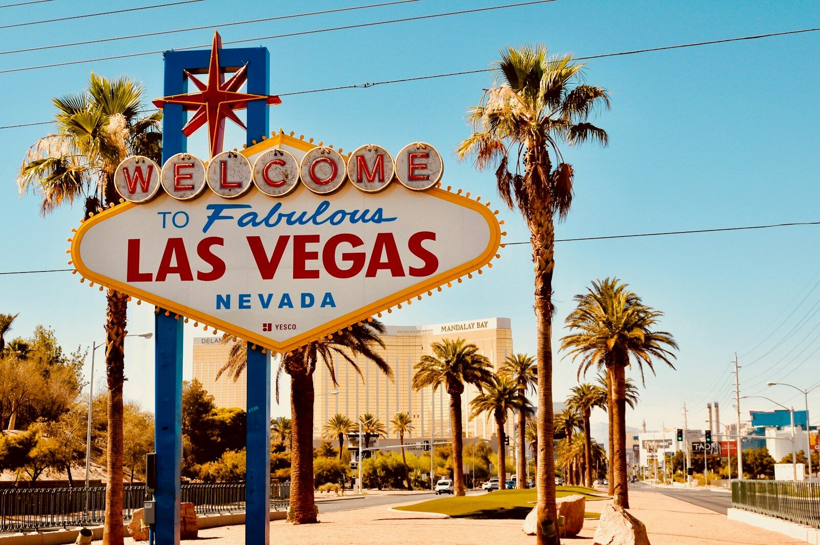 welcome to fabulous las vegas nevada signage with palm trees and blue sky behind