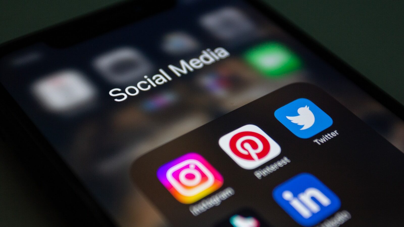 a close up of a mobile phone with social media icons on it