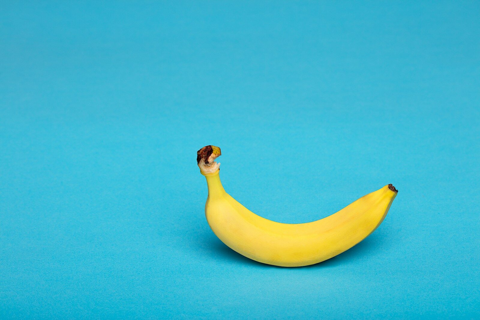 yellow banana fruit on bright blue surface