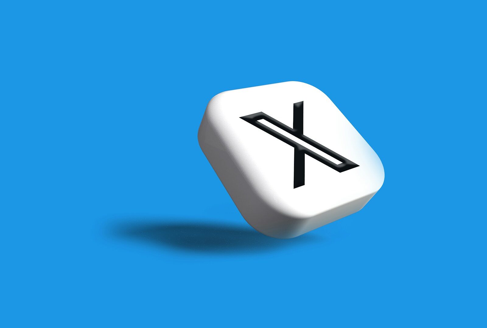 a white dice with a black x on it on a blue background