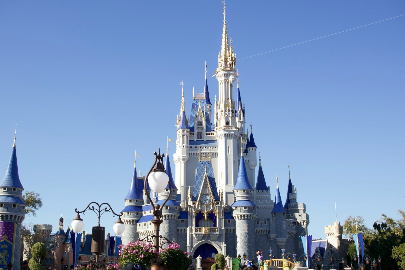 A grand castle with blue turrets under a clear sky