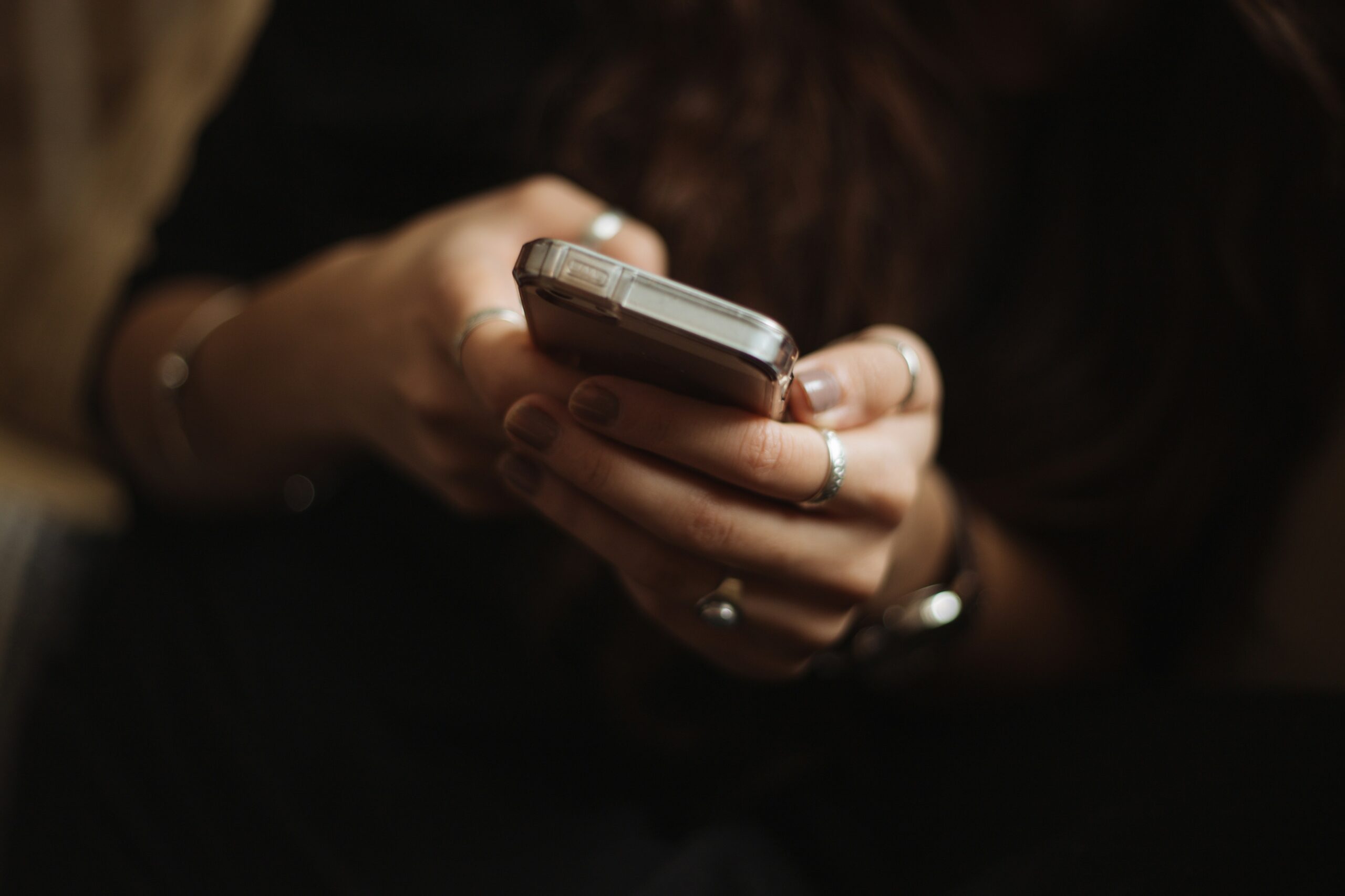 woman holding phone in hands