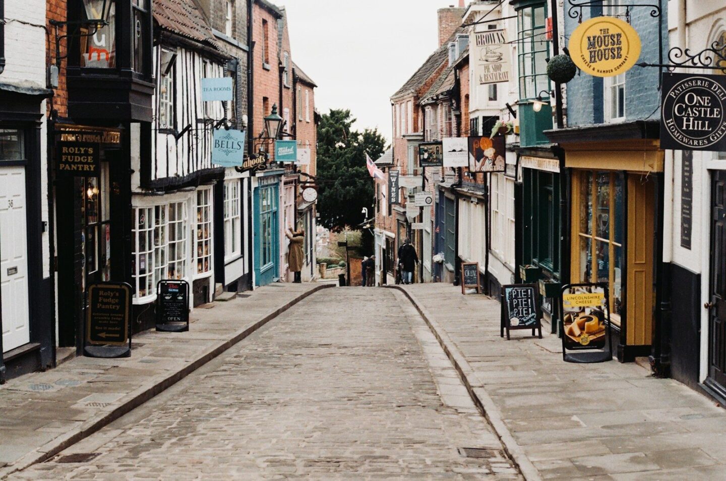 a narrow street lined with buildings and shops