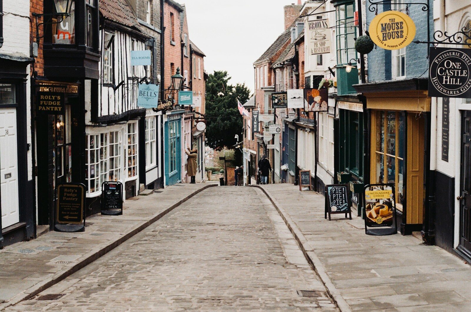 a narrow street lined with buildings and shops